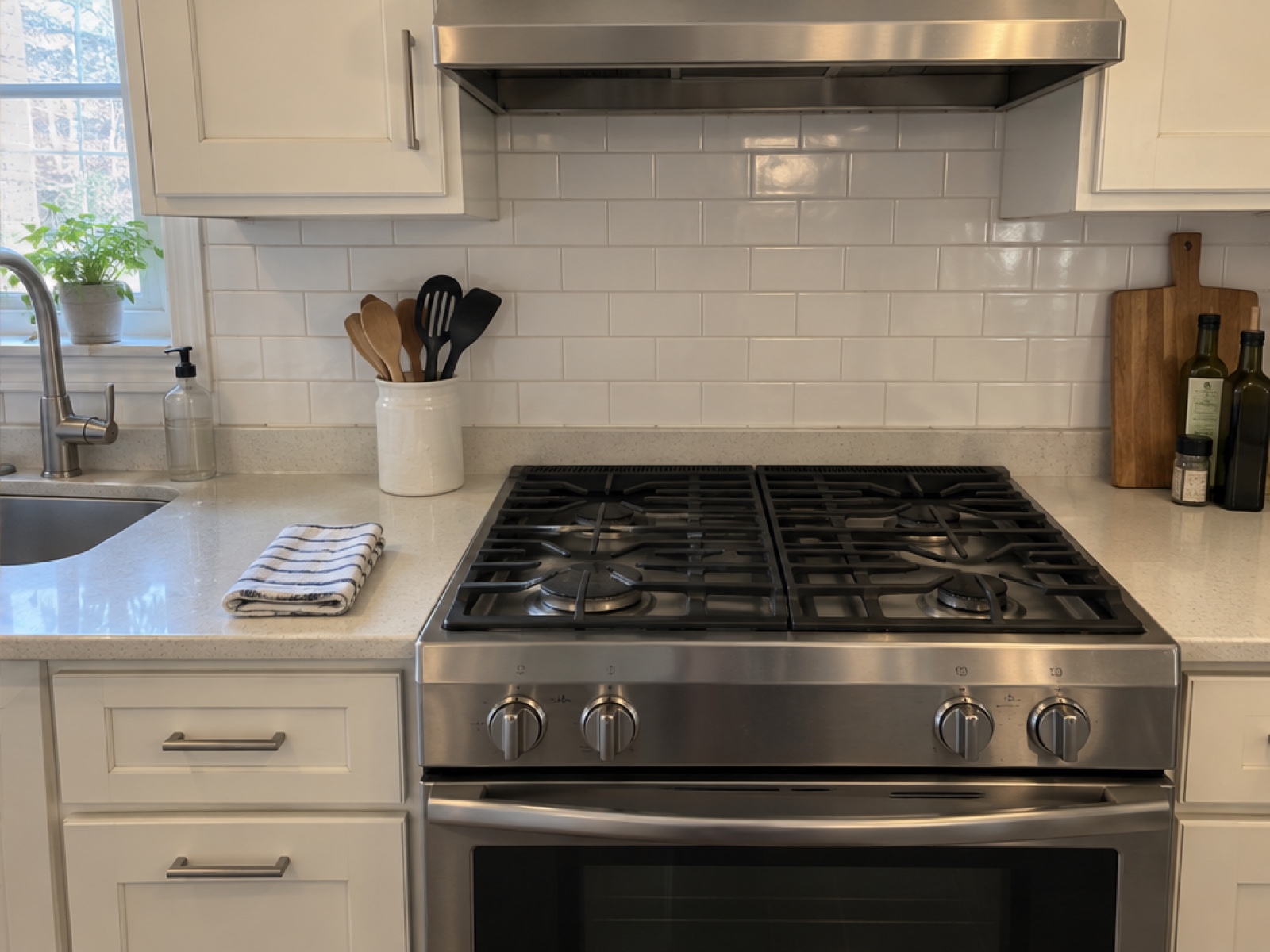 The same sample kitchen after cleaning, with a clean stove, backsplash and counter.